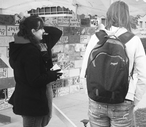 Wall of Oppression: Danielle Chambers and Caleb Amrchambault talk with students about the Writings on the Wall project and its importance. The wall will be up until the closing ceremony and tear down on Thursday at 11am on the quad, which is open to all who want to participate. Photo By: Kristyn Sonnenberg | Photo Editor Wall of Oppression: Danielle Chambers and Caleb Amrchambault talk with students about the Writings on the Wall project and its importance. The wall will be up until the closing ceremony and tear down on Thursday at 11am on the quad, which is open to all who want to participate. Photo By: Kristyn Sonnenberg | Photo Editor