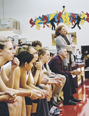 Leader of the Pack: Coach Tracy Dorow stands to watch her team contend with an opponent in a recent game. Dorow has spent the past eight years leading the team to victory. Photo By: Kristyn Sonnenberg | Photo Editor