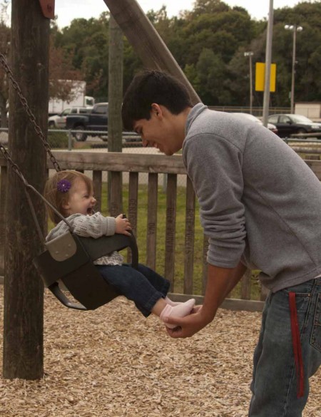 Juggling Life: Ethan Pineda and daughter Alivia play on the swings at Hemlock Park. Pineda currently works several jobs while taking 16 credits and raising his daughter. Photo By: Kate Dupon | Photo Editor Juggling Life: Ethan Pineda and daughter Alivia play on the swings at Hemlock Park. Pineda currently works several jobs while taking 16 credits and raising his daughter. Photo By: Kate Dupon | Photo Editor