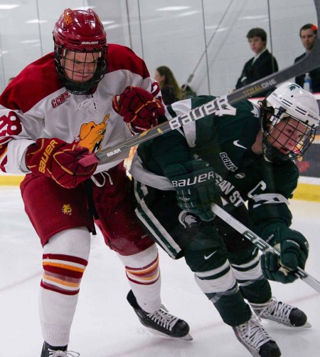 Entering the WCHA: Kyle Bonis, junior left wing, pushes past a Michigan State player during a 2010-11 season game. The Bulldogs will join the WCHA conference beginning in 2013. Torch File Photo Entering the WCHA: Kyle Bonis, junior left wing, pushes past a Michigan State player during a 2010-11 season game. The Bulldogs will join the WCHA conference beginning in 2013. Torch File Photo