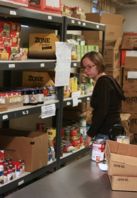 Helping Those in Need: April, a volunteer at Project Starburst helps to get packages ready to send out to those in need. The Ferris State Holiday Drive is now underway; students can drop non-perishable items off at any donation box located on campus. The donations will be distributed to Project Starburst. Photo By: Kate Dupon | Photo Editor