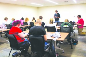 Ferris criminal justice junior and Acaholics vice president Tyler Karum practices his a capella skills to Acaholics members.