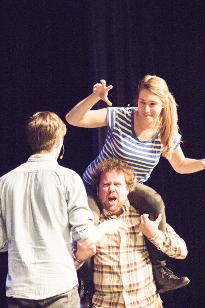 UCB TourCo’s Connor Ratliff hoists a “costume” onto his shoulders at a fictitious anime convention during TourCo’s performance in Williams Auditorium.